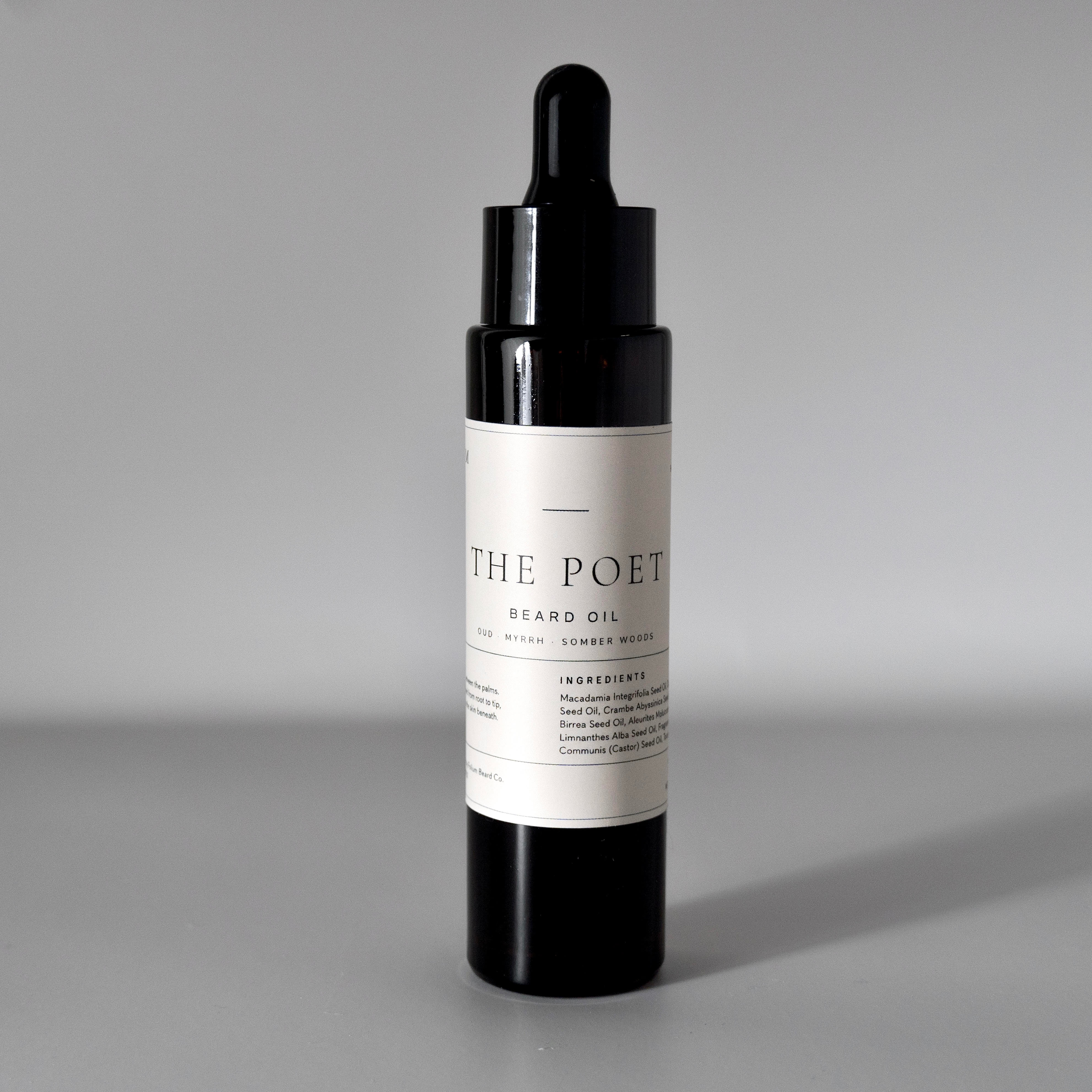 The Poet oud and myrrh beard oil in a 50 ml bottle on a cool grey background.