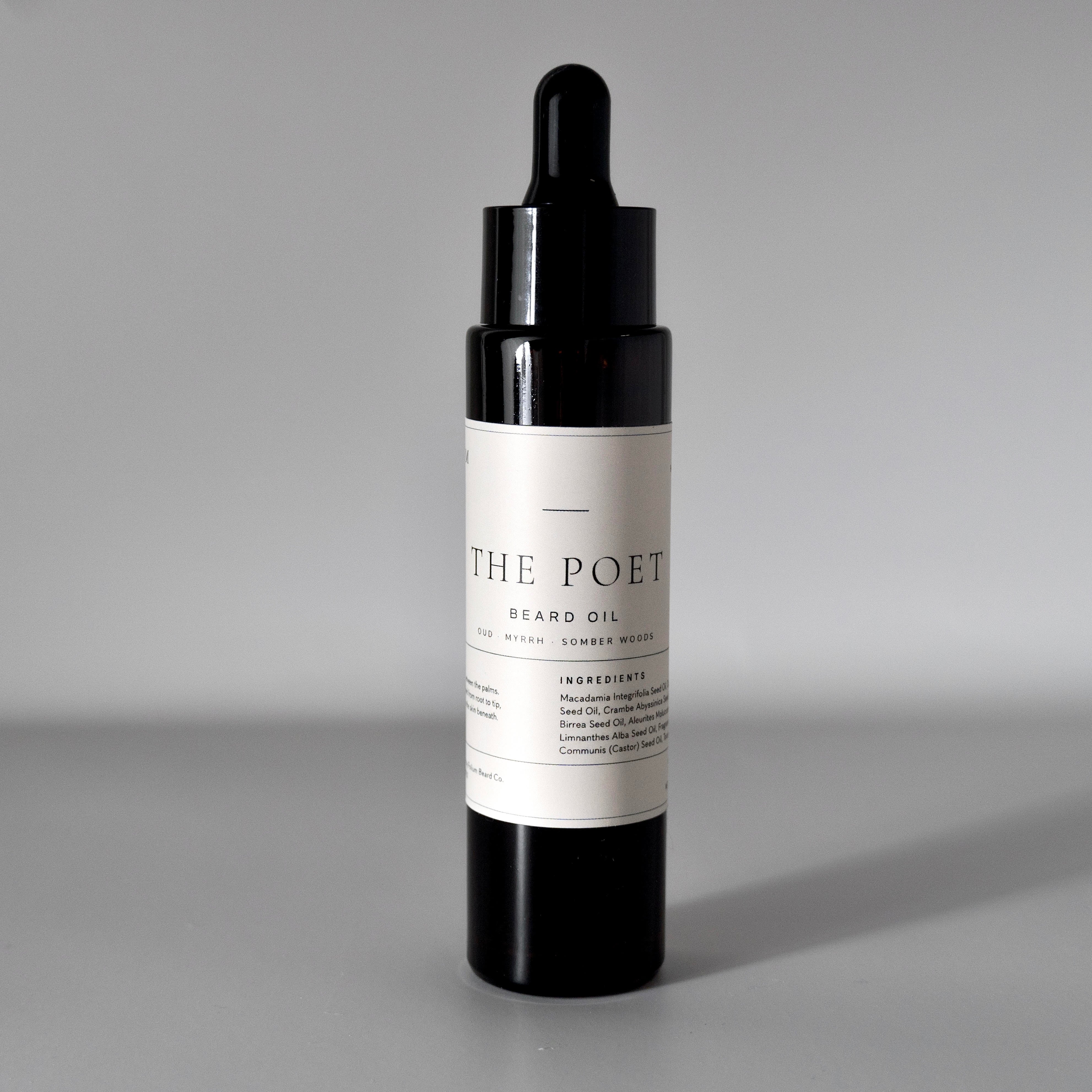 The Poet oud and myrrh beard oil in a 50 ml bottle on a cool grey background.